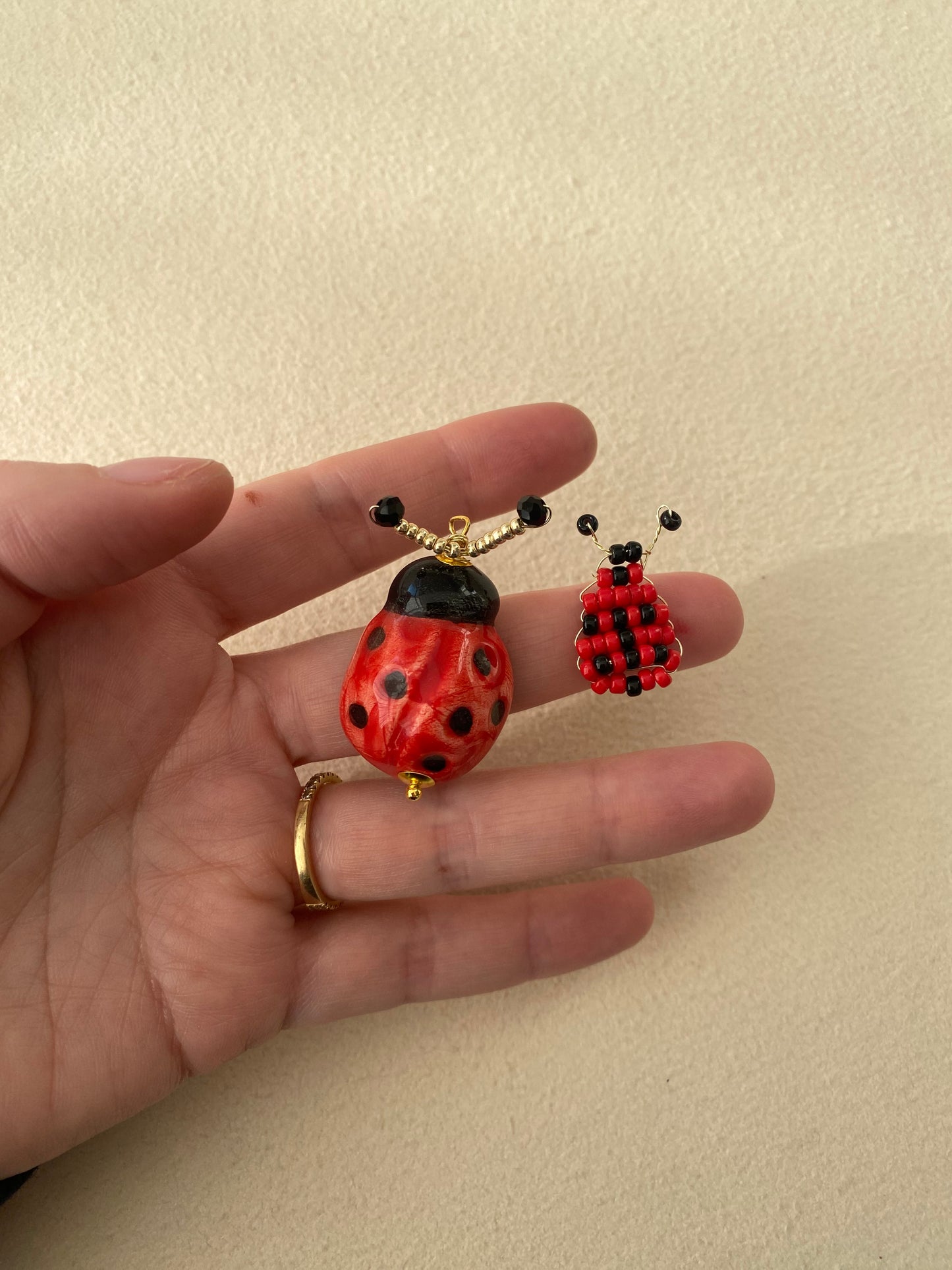 Colgantes de mariquita uno de cerámica esmaltada y otro de cuentas. Cashfana.