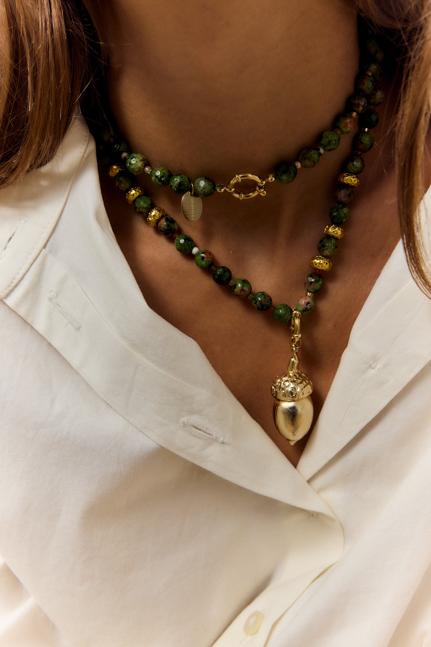 GOLDEN ACORN NECKLACE, LONG WITH DARK GREEN BEADS AND A BRONZE ACORN-SHAPED PIECE