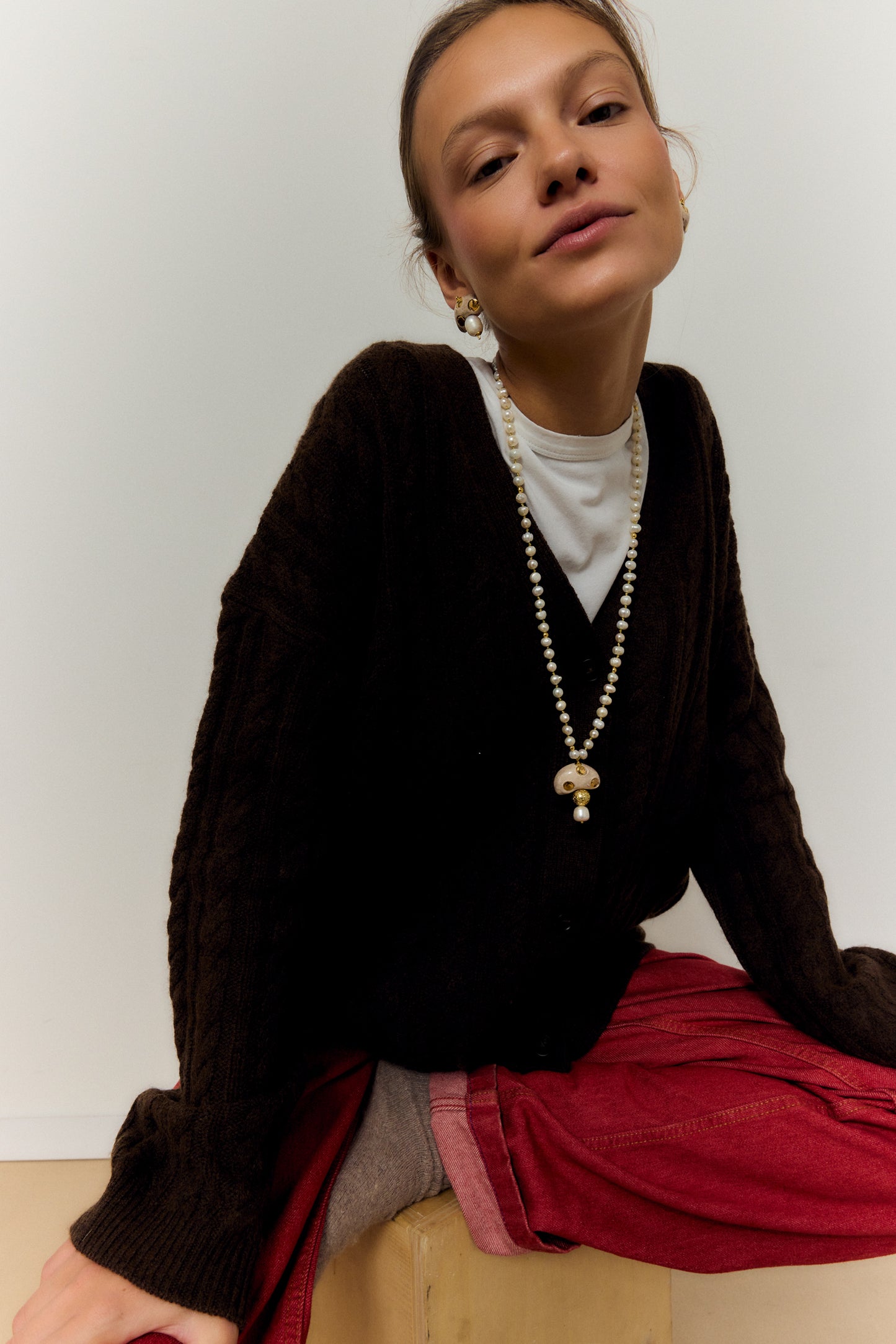 CHAMPI TOPO, LONG PEARL NECKLACE WITH BROWN MUSHROOM PENDANT.