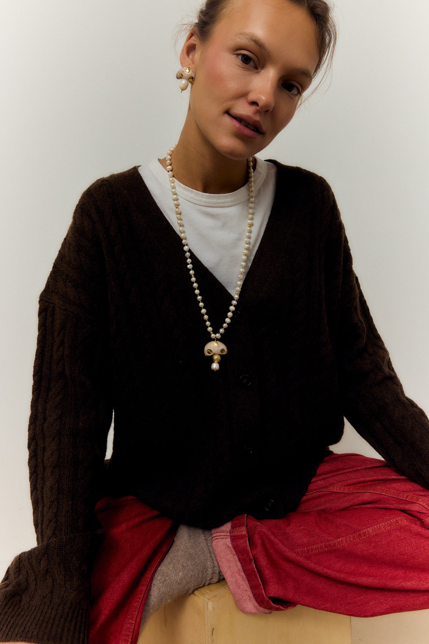 CHAMPI TOPO, LONG PEARL NECKLACE WITH BROWN MUSHROOM PENDANT.