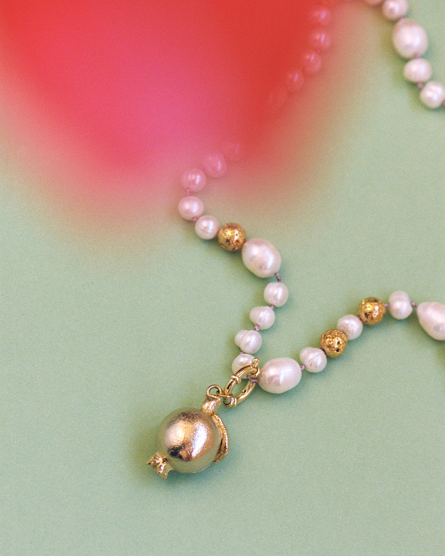 GRANADA DORADA, LONG PEARL NECKLACE WITH BRONZE PIECE IN THE SHAPE OF A GRENADE