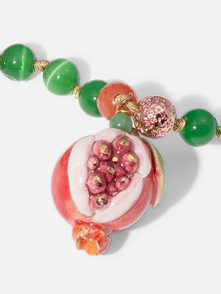 OPEN POMEGRANATE, LONG GREEN AND RED BEAD NECKLACE WITH PIECE OF CERAMIC IN THE SHAPE OF A POMEGRANATE